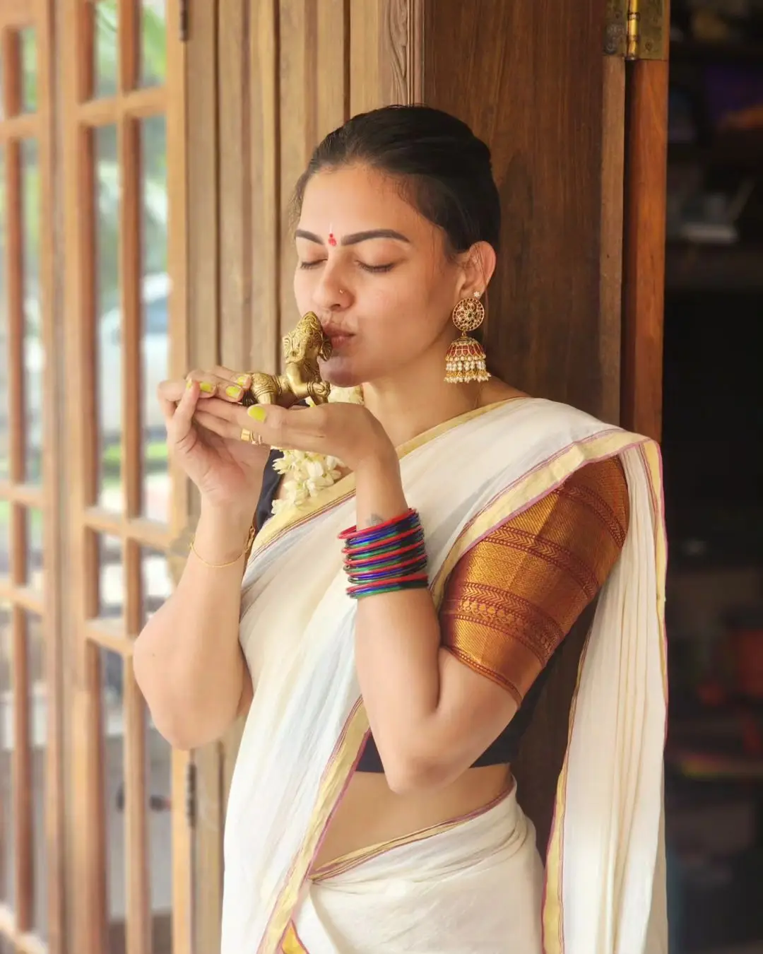 Anusree Nair Wearing Beautiful Earrings Jewellery White Saree Orange Blouse